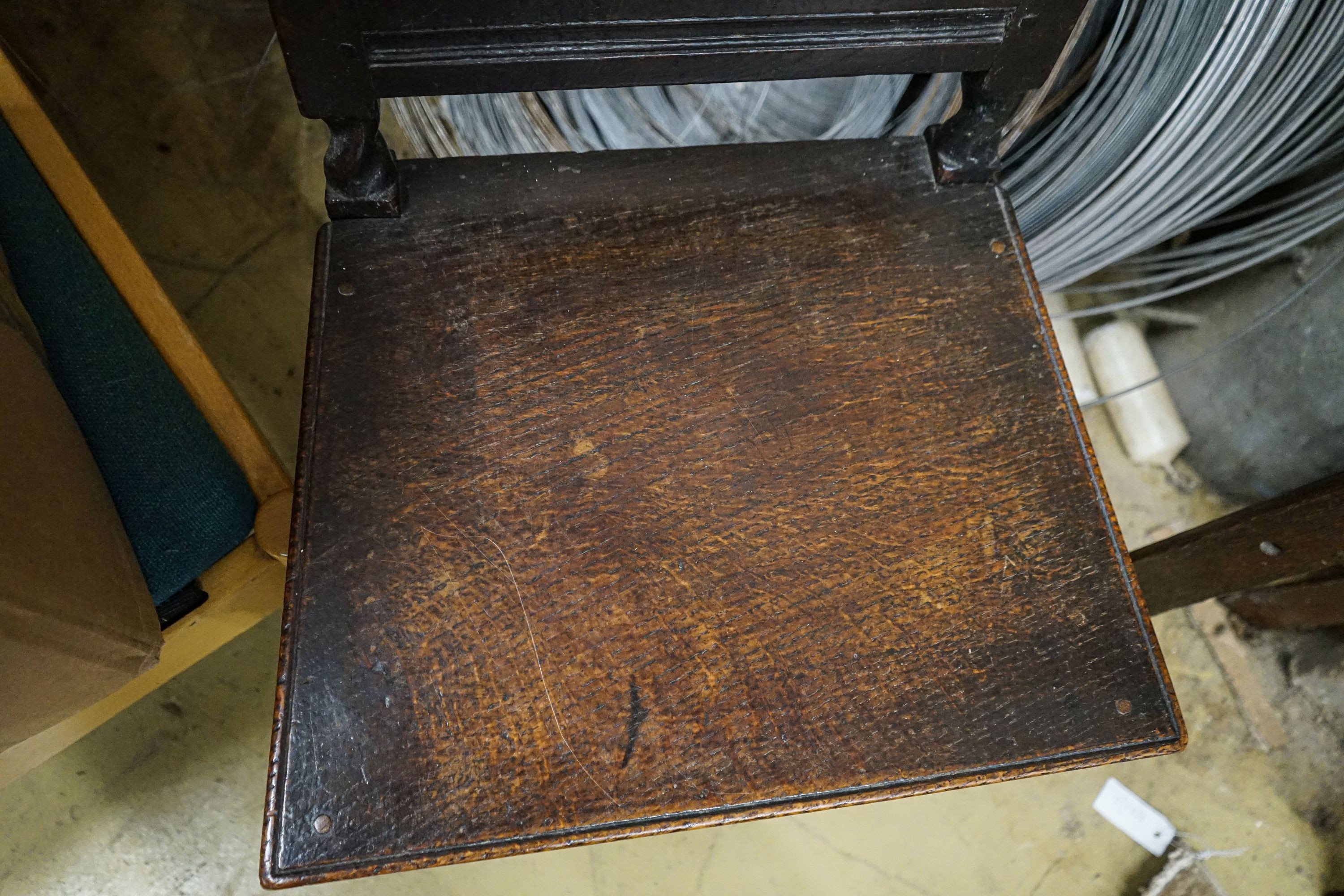 A 17th century oak dining chair, with carved panelled back, solid seat and barley twist stretchers, width 49cm, depth 39cm, height 96cm